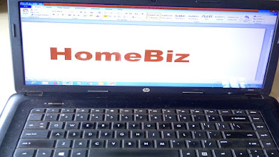 Red HomeBiz sign on computer screen.