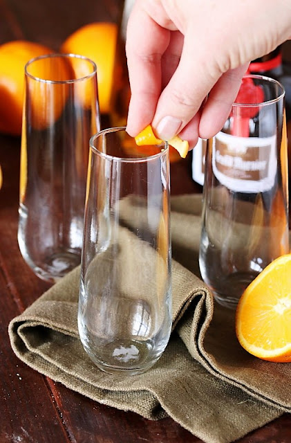 Rubbing Champagne Flute Rim with an Orange Twist Image