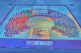 Pixelated photo of figures in different colours representing MEPs from different parties in the Parlamentarium in Brussels