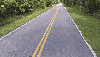What double solid yellow line on the road means