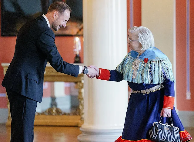 Crown Princess Mette-Marit wore a silk blouse and navy blue skirt. Queen Sonja wore a floral print midi dress