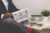 Business man reading newspaper