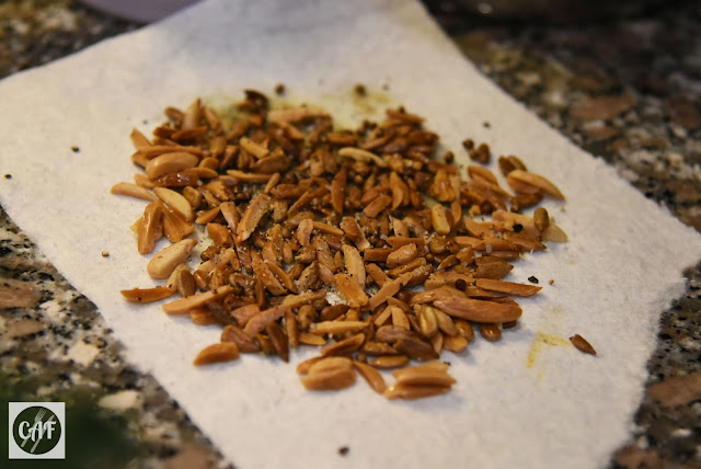 Fried slivered almonds, sunflower seeds and coriander seeds for a grain bowl