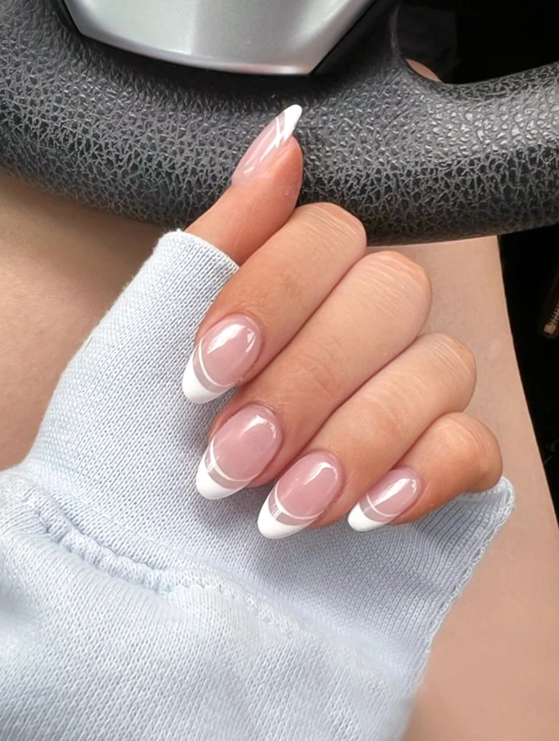 close-up of a ebautifully manicured woman's hand with a french tip design