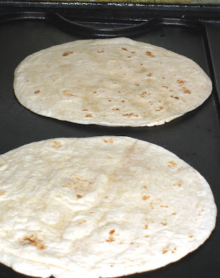 Heat flour tortillas on a griddle