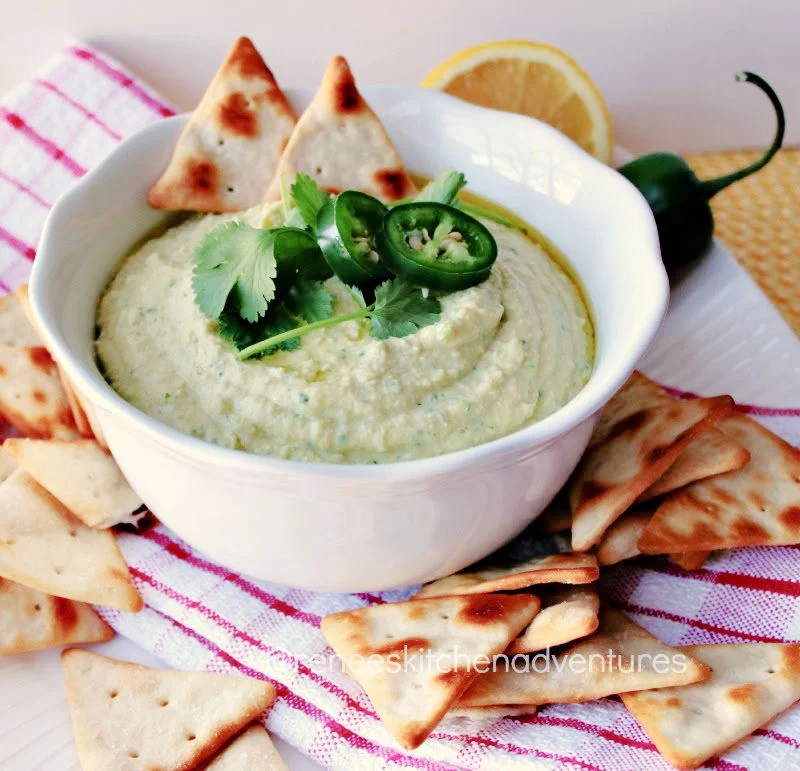 Jalapeno Cilantro Hummus in a bowl with pita chips ready to eat