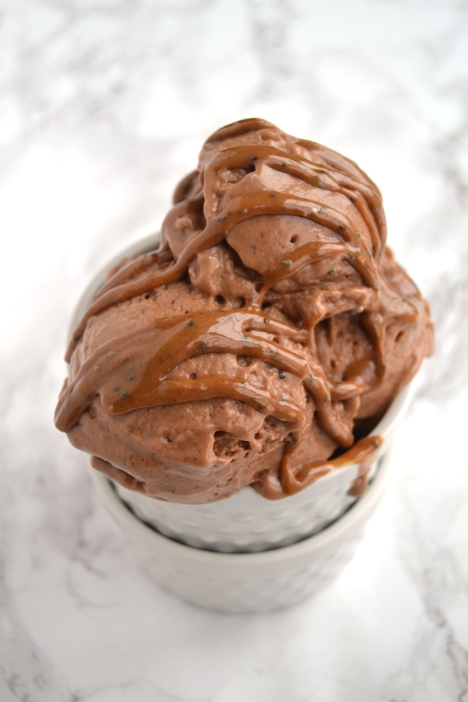 Chocolate Peanut Butter Banana Ice Cream is made with 4-ingredients: frozen bananas, peanut butter, cocoa powder and milk, takes 2 minutes to make and is super rich and creamy for the perfect dessert! www.nutritionistreviews.com