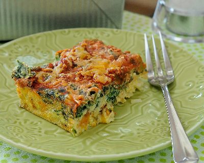 A square of Easy Make-Ahead Breakfast Casserole, a master recipe ♥ KitchenParade.com. Start with eggs, frozen hash browns, salsa and cheese, then adapt as you like, incl on-the-go muffins and individual ramekins.