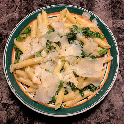 Penne tossed with with broccoli rabe sautéed in garlic and olive oil and topped with shaved parmesan