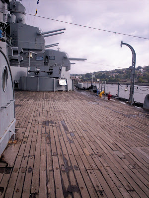 Stepping onto wooden deck on the USS Massachusetts crowned by the jumble of