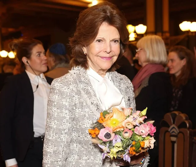 Queen Silvia wore an embellished boucle tweed blazer jacket by Zara, and brown fur long coat