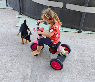 Rosie riding her trike