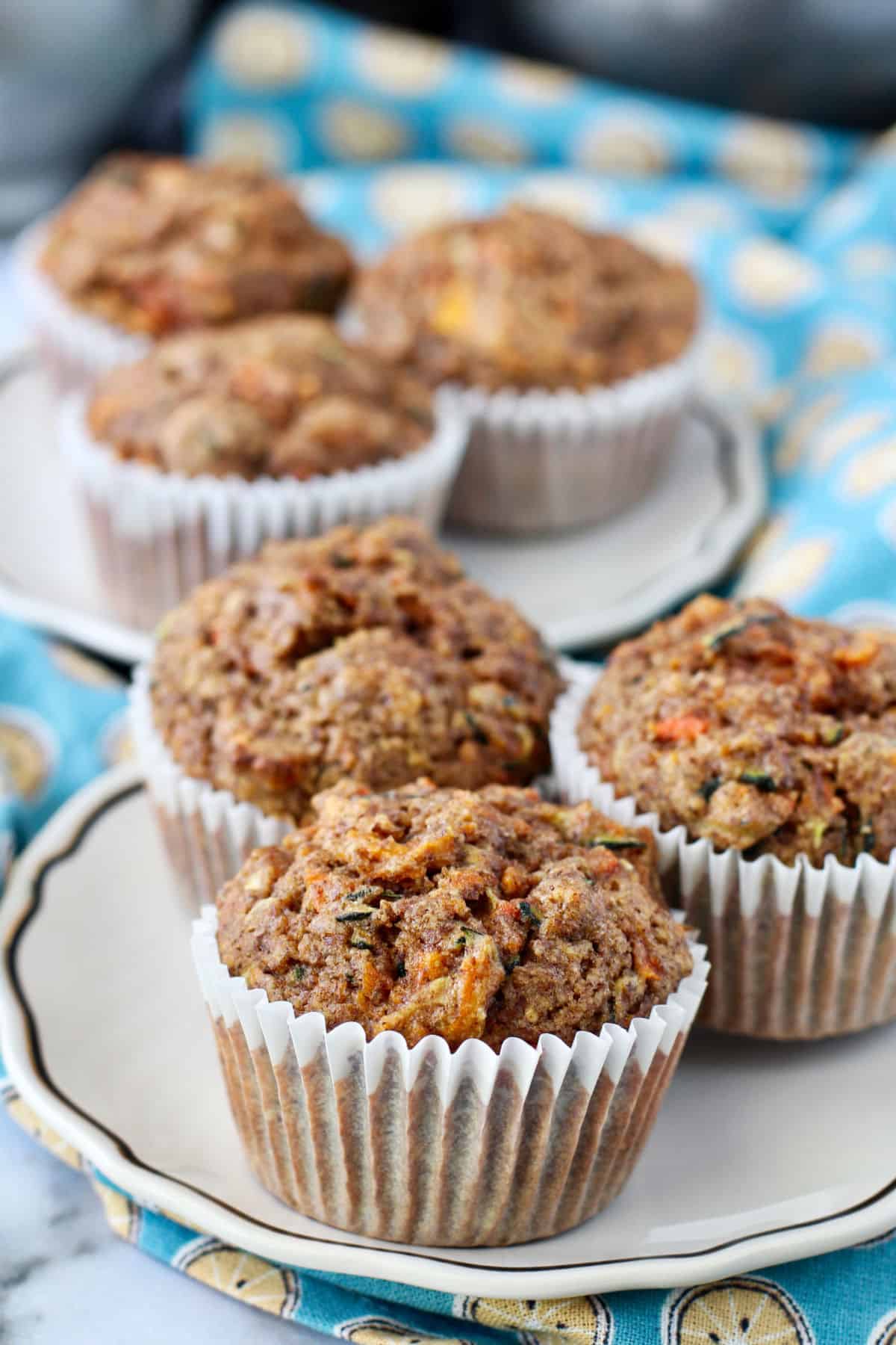 Zucchini Carrot Muffins on white plates.