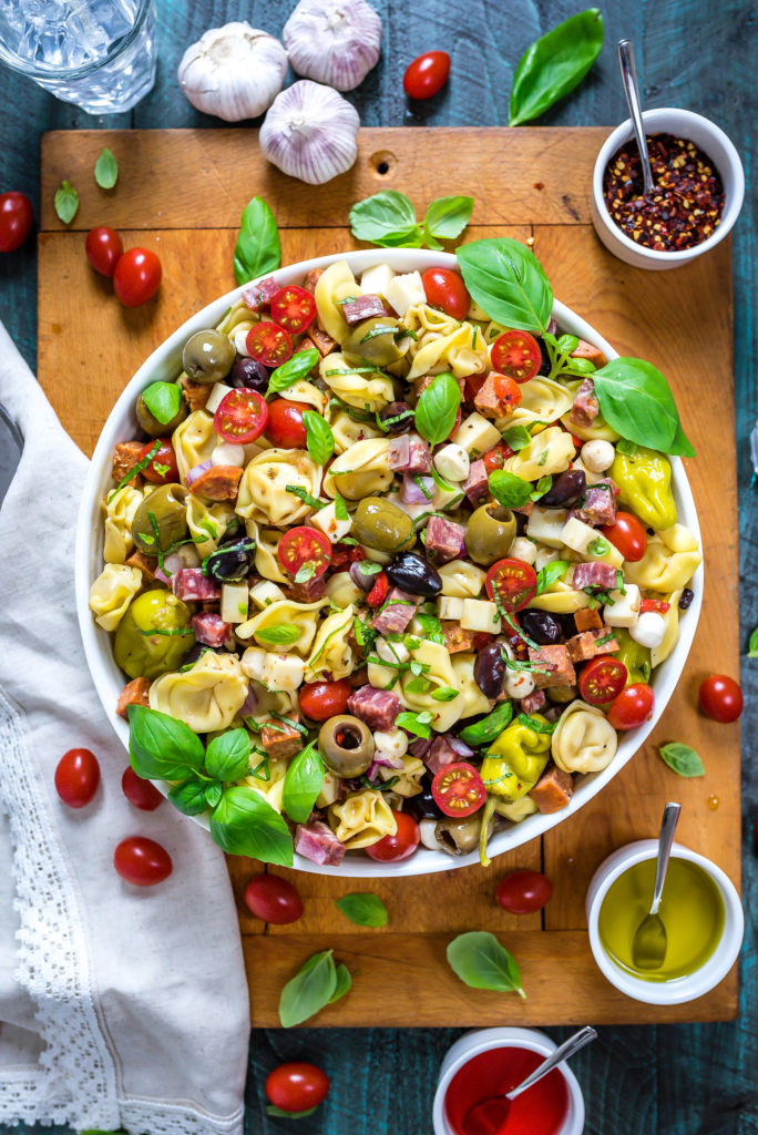 This packed potluck favorite includes multiple cheeses, meats, olives, peppers, and more to create a hearty Italian-inspired summer side dish.