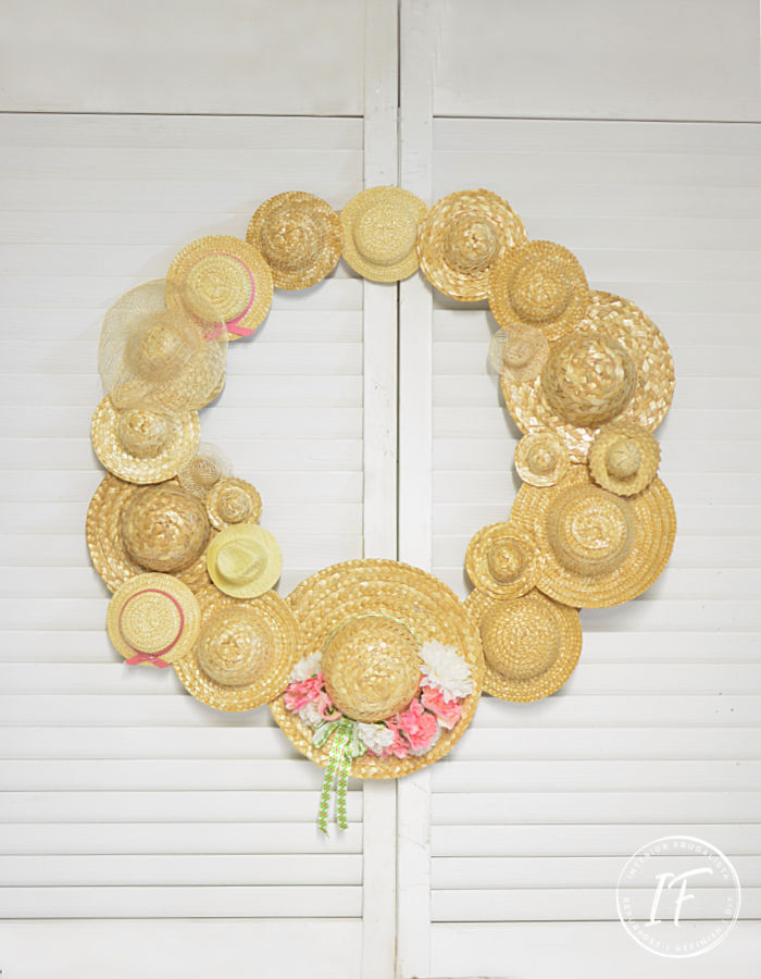 An easy DIY Summer Hat Wreath idea with recycled miniature straw hats. A budget-friendly summer craft idea with thrift store and dollar store finds.