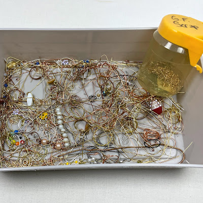 plastic container with wire scraps from jewelry making