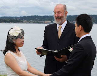 Shanshan and Wei hold hands while Kent Buttars of A Heavenly Ceremony officiates