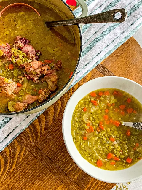 Hearty Split Pea Soup is made with a meaty hambone, generous carrots, onions, and celery, yielding a flavorful broth.  It is easy to make on the stovetop, but I have added a slow cooker and instant pot option.