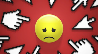 Se observa un emoticón con gesto de tristeza apuntado por signos informáticos