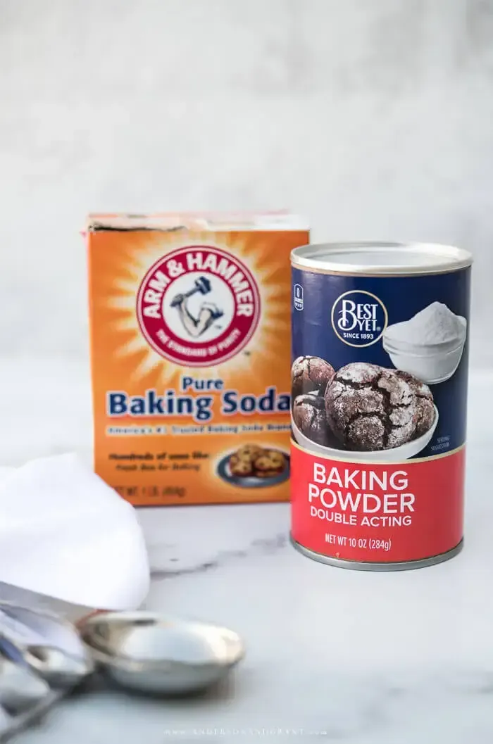 Boxes of baking soda and baking powder on marble counter