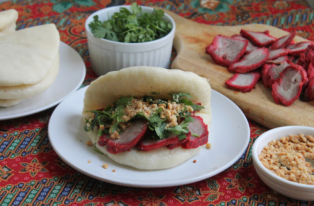 Food Lust People Love: Tiger Biting Pig Buns are soft, steamed bread filled with slices of rich char siu pork, fresh cilantro and roasted peanuts with a little sugar. Each bite is more delectable than the next!