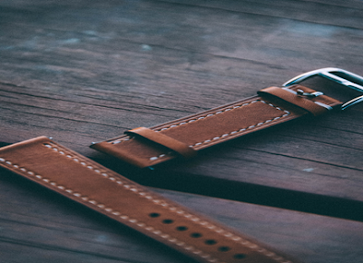 A Brown Leather Strap with Metal Buckle