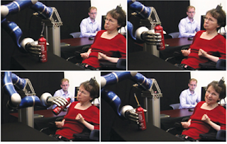 Picture of a Lady using a Robotic Arm to Drink