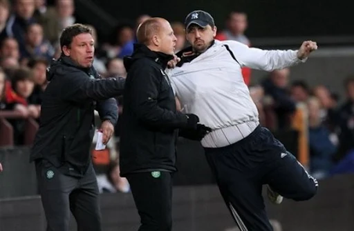 Glasgow Celtic manager Neil Lennon is attacked on the touchline by a fan