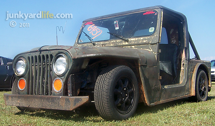 A junked Jeep CJ7 on top of a wrecked Mazda Miata It's what happens after