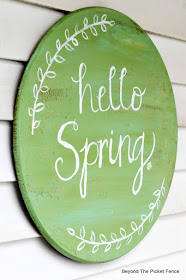 hello spring sign hand painted on an old table top