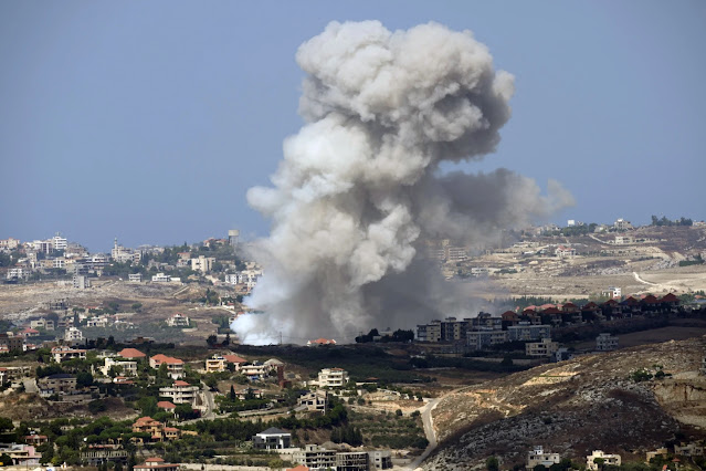 Smoke rises from an Israeli airstrike on Kfar Rouman village, as seen from Marjayoun town, south Lebanon, Monday, Sept. 23, 2024. (AP Photo/Hussein Malla)