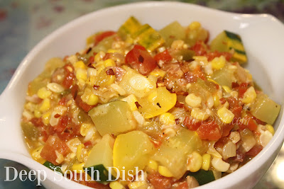 A skillet meal of zucchini, corn, onion and tomatoes with garlic, that can be used as a side dish or served stuffed into warmed corn tortillas, for a vegetable taco.