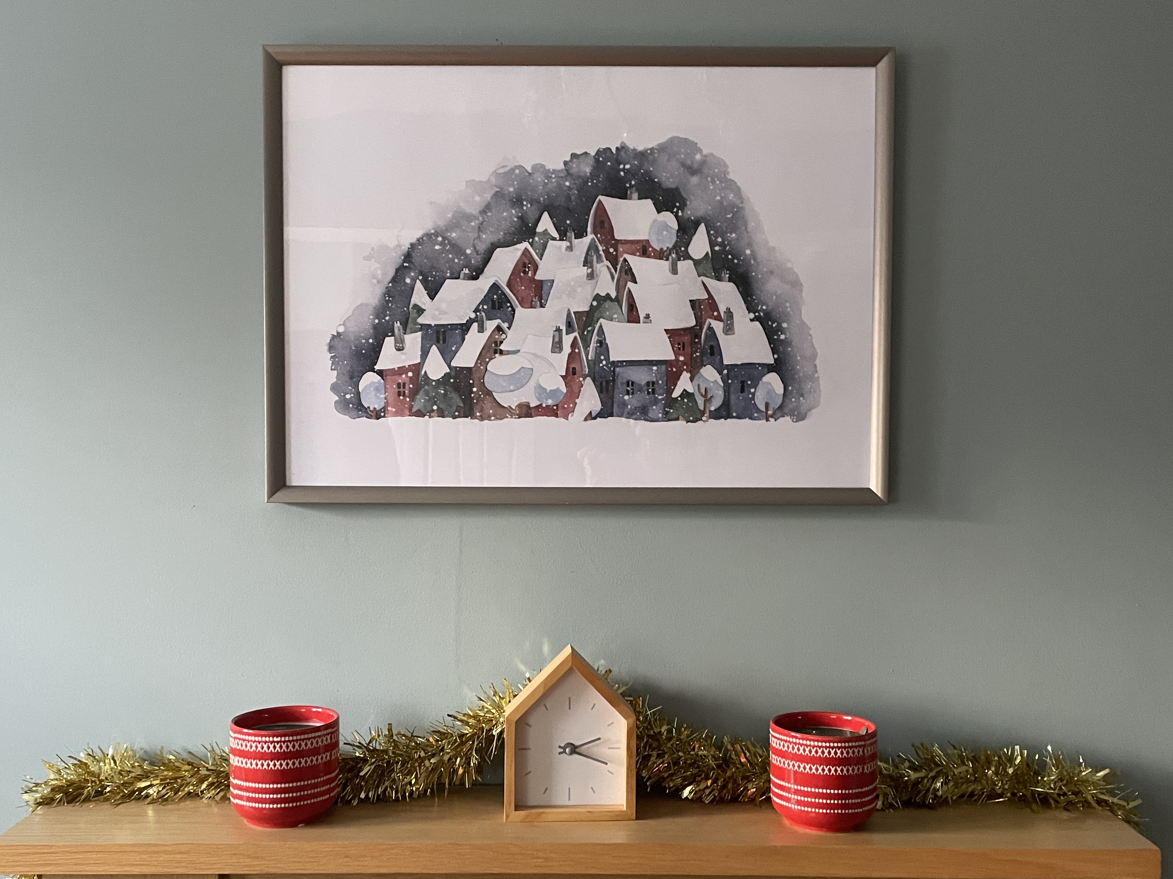 christmas poster above a fireplace