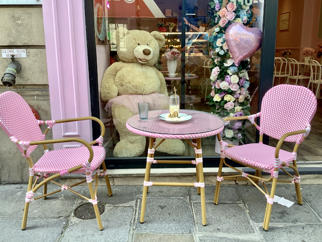 Pink cafe chairs and table with large teddybear