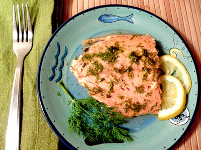 Reheated salmon served with lemon and dill garnish