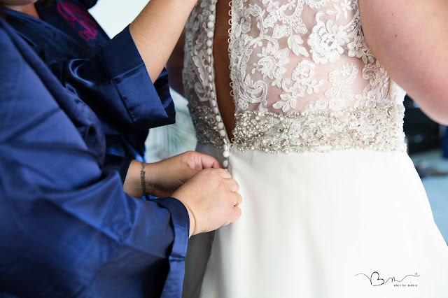 bride getting on dress