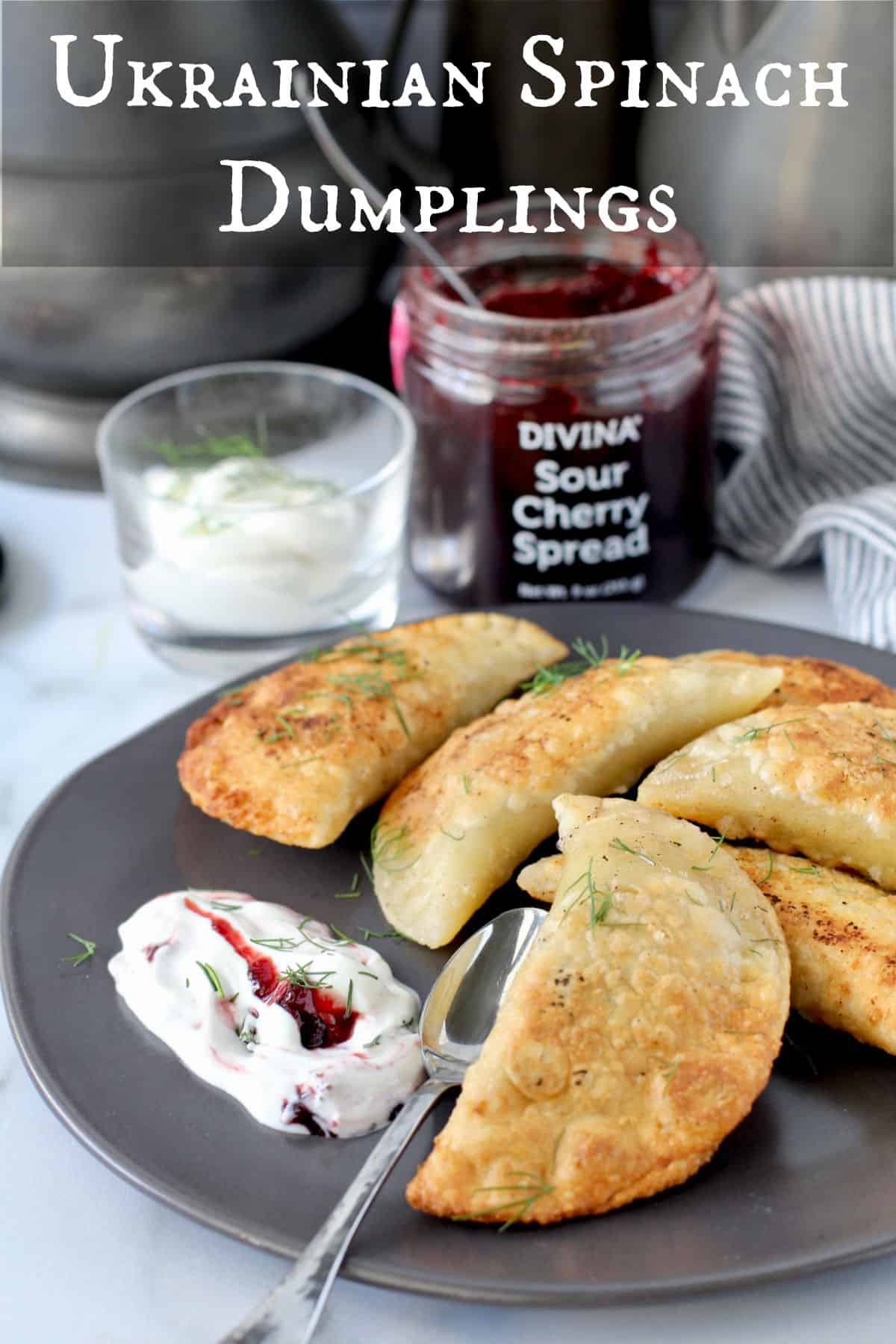 Ukranian Spinach and Potato Dumplings on a plate with sour cream.