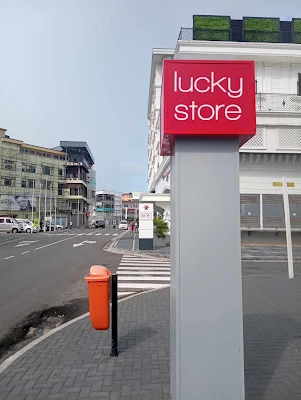 " Lucky Store billboard sign in the city of Paramaribo in front of their store"