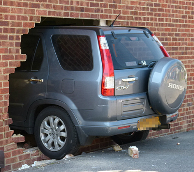 Honda crv crashes through wall