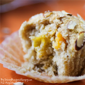 Moist muffings filled with mango and topped with sliced almonds on Anyonita Nibbles from Dizzy Busy and Hungry
