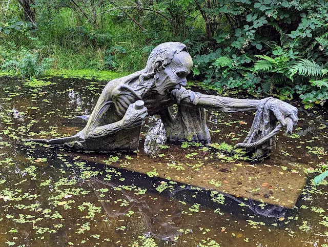 Scary sculpture emerging from a pond at Victor's Way in County Wicklow