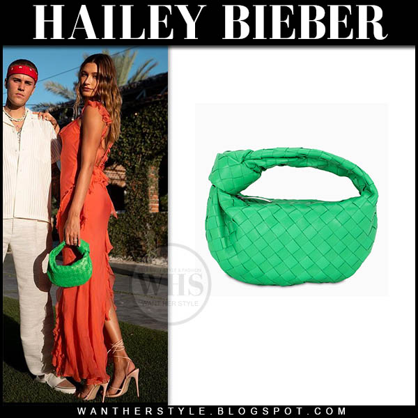 Hailey Bieber in orange dress and green bag