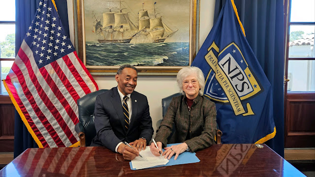 USU President Dr. Jonathan Woodson and Naval Postgraduate School President Dr. Ann Rondeau sign a Memorandum of Agreement to identify and foster collaborations in areas such as modeling, simulation, virtual environments, computer programming, and human factors development. (Photo by Sharon Holland)