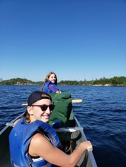 Woman and girl in canoe on lake
