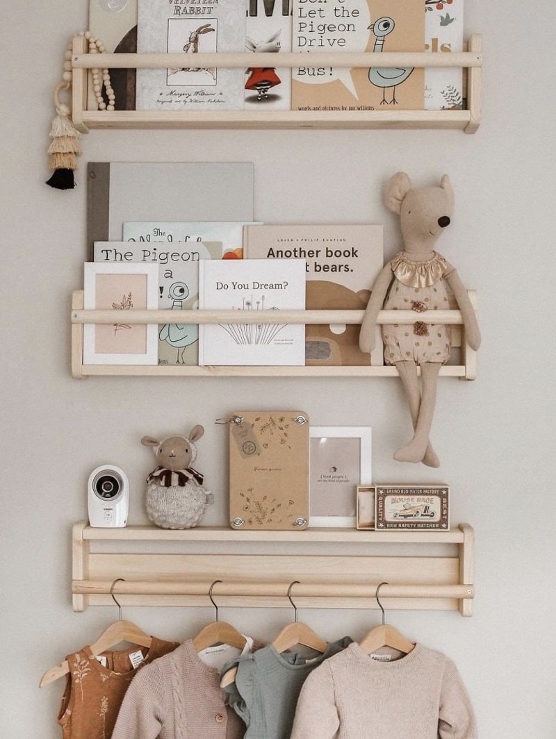 ikea flisat shelves with book, toys and clothes on them