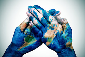 Pic of two hands with world map painted on them