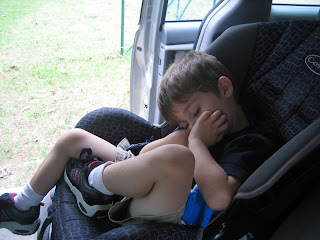 toddler boy sleeping in car seat in summer