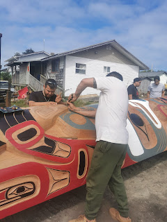 Carvers working on new totem pole in Old Masset