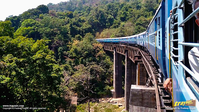 Train moving through bridge and into tunnel in Shiradi Ghats section of Sahyadri - Western Ghats