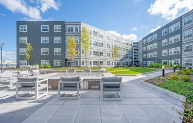 Exterior image of The Val with outdoor firepit with seating and courtyard